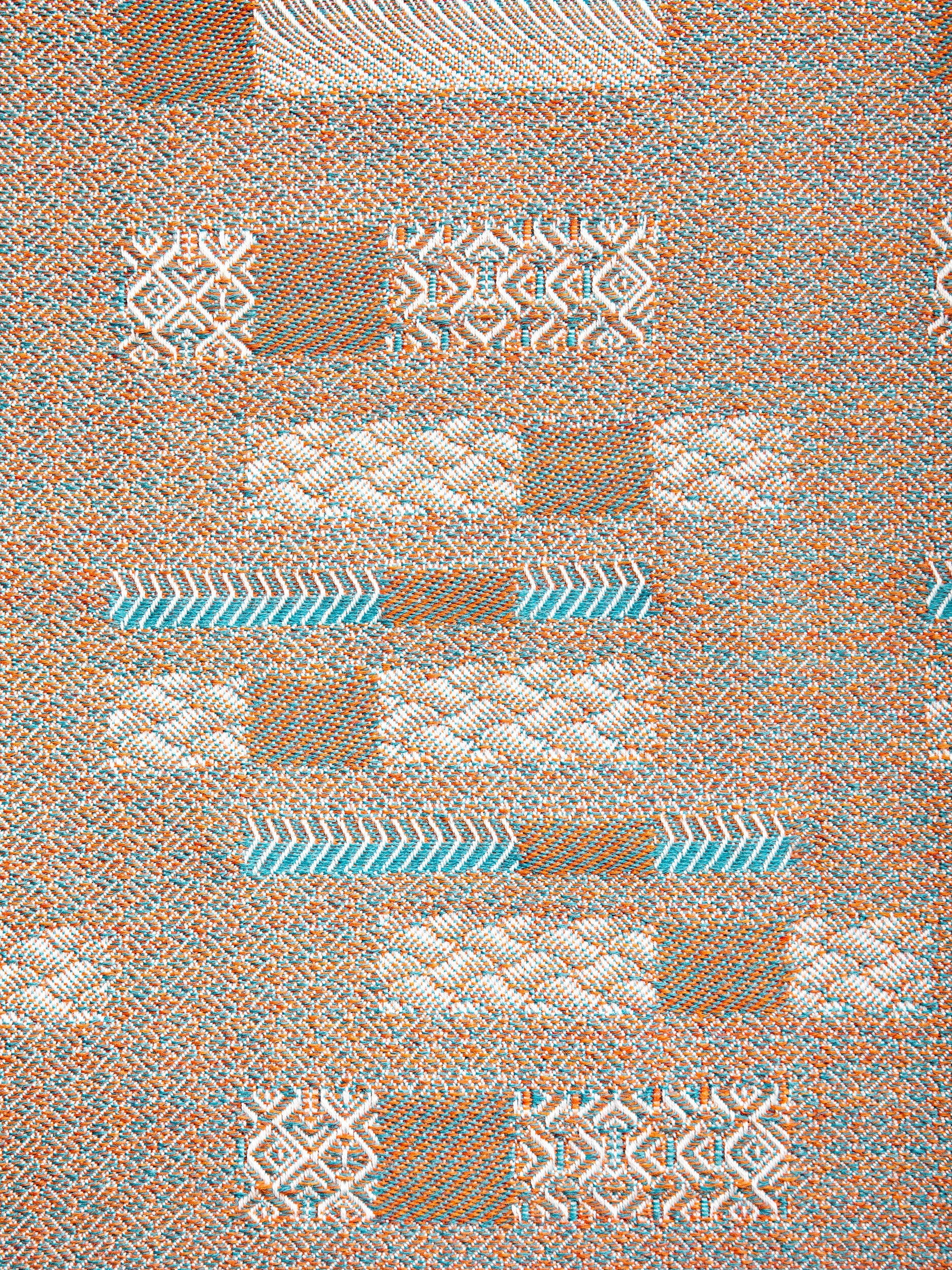 "Aurea" wool throw in Sedona Orange